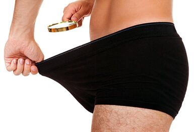 A man looks at the size of his penis